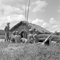 "Ashau-Laos Border", a group of soldiers standing in the middle of a grass field