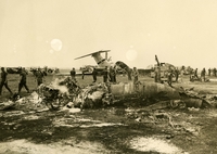 Appears to be the remains of some kind of aircraft. Several military personnel are surrounding the debris in the background.