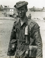 "John Schneider - a portrait of a soldier." A dirty US Army soldier looks at the camera.