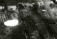 "A U.S. Navy A4 Skyhawk from the Seventh Fleet carrier USS Bon Homme Richard pulls away as a napalm bomb explodes during action against the Viet Cong on July 1 southwest of Saigon. Pilot of the aircraft was Ens. R. W. Nielson of Sacramento, Calif." A US Air Force jet flying over rural land.  Some of the trees appear to be on fire.