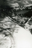 "Post-Strike photograph taken after the strike by pilots from Oriskany's carrier air wing sixteen against the Haiphong Highway Bridge SSE, two miles south of the North Vietnamese Prot City on 4 September. The northern end of the bridge is completely destroyed and spans were dropped in the water." Aerial photography of a destroyed bridge over a river.