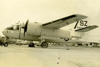 "The US2B is a twin-engine, six seat utility aircraft." A US Marine Corps plane sitting in an airfield. (damaged)