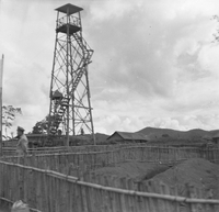 "Montagnards - Showplace Strat. Ham - 8-21-62 - In MTs - Faces - Blockhouses " A watchtower with a Vietnamese soldier standing near the bottom.