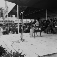 Original caption: "Mne. Nhu + Paramilit. Graduation - 27 Feb 63" Madame Nhu (Tran Le Xuan) sitting on a stage.