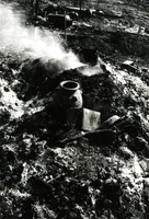 Some pottery sitting on the ground. Smoke and other debris surround it.