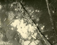 "Before and After near Thanh Hoa, North Vietnam - Navy jet pilots of Carrier Air Wing 15 pounded a railroad ferry complex northeast of Thanh Hoa Sep. 21-23, 1966. Targets included a thermal power plant, defending flak sites, railways, boxcars, and roads. After the raid shown in these before and after photos, Navy Intruder and Skyhawk pilots described the area as 'devastated.'" Aerial photo of a crater pocked landscape, including a bombed railway and farms.