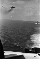 "7th Fleet" A view of the open ocean. An aircraft carrier and two planes can be seen in the background. Photo taken from a second aircraft carrier.