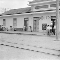 "QN + Train "photo of a front of a hospital, people standing around and talking