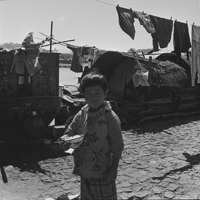"Macau" Young child hold a bowl of rice as his picture is taken.
