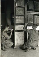 "Pleiku, Vietnam (Army IO) - Helping to renovate the sector girls' school here are PFC Ted Drozdowski, Lake Hamilton, Fla., and PFC Robert Harvey, Princeton, NJ. Both are members of the Army's 173rd Airborne Brigade. The school has been closed for several months because of damages incurred during its emergency use as refugee and troop quarters." Two American soldiers paint a wall, possibly in a school. There is children's writing on the wall.