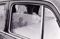Henry Cabot Lodge Jr seated inside a car. It appears to be raining outside.