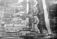 An aerial photo of a city or military camp with old fortress walls and a moat.