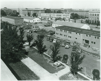 Temporary buildings in foreground, with Burnett Hall under construction. Partially demolished old Nebraska Hall is in the upper left corner.