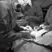 An American doctor attaches a clamp during surgery.