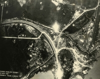 "Before and After near Thanh Hoa, North Vietnam - Navy jet pilots of Carrier Air Wing 15 pounded a railroad ferry complex northeast of Thanh Hoa Sep. 21-23, 1966. Targets included a thermal power plant, defending flak sites, railways, boxcars, and roads. After the raid shown in these before and after photos, Navy Intruder and Skyhawk pilots described the area as 'devastated.'" Aerial photo of a bombed landscape with railroads, a river, farm fields, a village, and roads.