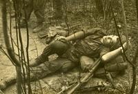 "Sleepy Time. Sgt Carlos Irizarry, from Brooklyn, takes a well deserved break in a landing zone after a hard day of going through the jungles of Tay Ninh Province. His unit, the 2nd Bn, 16th Inf. 'Rangers' was participating in the 1st Inf Div.'s biggest operation to date in Vietnam, Operation 'Junction City.'" An American soldier resting on the forest floor.