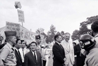 Robert McNamara and Henry Cabot Lodge, Jr., stands with government and military officials, posing for the press.