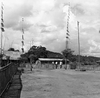 "Montagnards - Showplace Strat. Ham - 8-21-62 - In MTs - Faces - Blockhouses" Some men are standing near a fence.