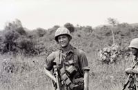 Two American soldiers standing in a field.