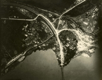 "Before and After near Thanh Hoa, North Vietnam - Navy jet pilots of Carrier Air Wing 15 pounded a railroad ferry complex northeast of Thanh Hoa Sep. 21-23, 1966. Targets included a thermal power plant, defending flak sites, railways, boxcars, and roads. After the raid shown in these before and after photos, Navy Intruder and Skyhawk pilots described the area as 'devastated.'" Aerial photo of a landscape with roads, a village, a railway, a river, and farms.