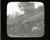Original caption: The flint ledge at old quarry opp. So. Bend, Nebr. 1911 Group of men standing at base of flint ledge. Cass County. (121111-00247)