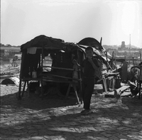 "Macau" Young boy is eating standing next to a wooden shop.