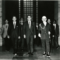 Clifford Hardin walks out of building doorway with two unidentified men, on is a guard, in Turkey.