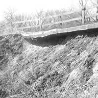 Original caption: Salt Creek bridge West of penitentiary detail of damaged paving. Apr. 16, 1922