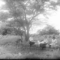Original caption: Outing party at Salt Basin, Lincoln, NE. Three unidentified seated women. June 4, 1916