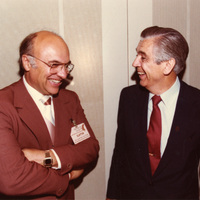Clifford Hardin and Clayton Yeutter stand together laughing.