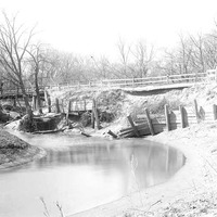 Original caption: Salt Creek bridge west of penitentiary from south showing bridge and undermined pavement. Apr. 16, 1922