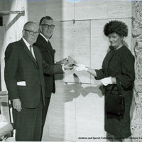 Isamu Noguchi on stairs with his commissioned sculpture, Song of the Bird.