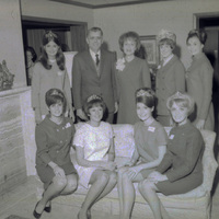 Original caption: "Big 8 Homecoming queens with Chancellor Hardin." Hardin and Martha Hardin stand with three homecoming queens while four of the queens are seated in front of them.