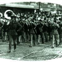 Picture of Carrol Panley (drum major) leading the R.O.T.C. Band down "O" street in Lincoln, Nebraska during the 1929 Armistice Parade.
